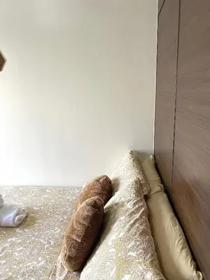 a stuffed animal is laying on a bed at Ikigai Delta Makati Condo Luxury Sunset View in Manila