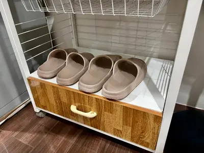 a drawer with four pairs of shoes in a closet at Ikigai Delta Makati Condo Luxury Sunset View in Manila