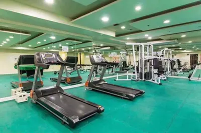 a gym with treadmills and elliptical machines at Explore Manila Trendy 1BR unit in Birch Tower in Manila