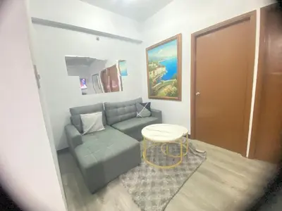 a living room with a couch and a table at Tiaras Luxury Condotel in Manila
