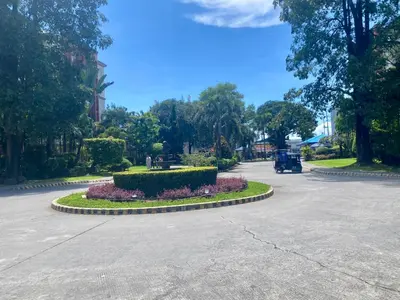 a street with a circle of flowers in the middle at Tiaras Luxury Condotel in Manila