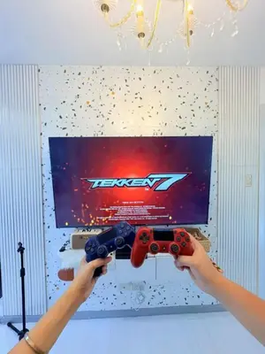 a person holding two video game controllers in front of a tv at Azure Resort Paranaque deluxe room unit 1601 st tropez tower in Manila