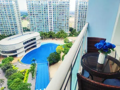 a balcony with a swimming pool and some buildings at Azure Resort Paranaque deluxe room unit 1601 st tropez tower in Manila