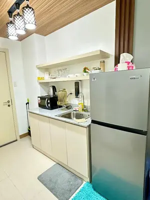 a kitchen with a refrigerator and a sink at Marias Crib in Manila