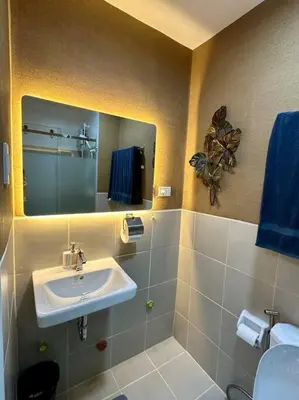 a bathroom with a sink and a mirror at Marias Crib in Manila