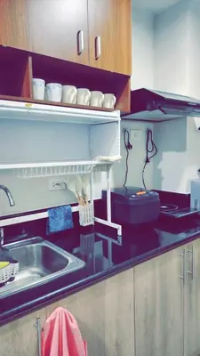 a kitchen with a sink and a counter top at Staycation by Estelle in Manila