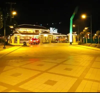 an empty parking lot at night with a gas station at Staycation by Estelle in Manila