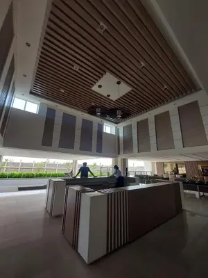 a lobby with two people sitting at desks in a building at Staycation by Estelle in Manila