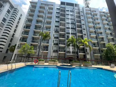 a large apartment building with a large swimming pool at One palm tree villas &Two palm tree villas in Manila