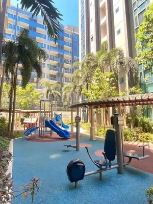a playground with a slide and a swing at One palm tree villas &Two palm tree villas in Manila