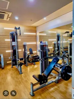 a gym with several tread machines in a room at One palm tree villas &Two palm tree villas in Manila