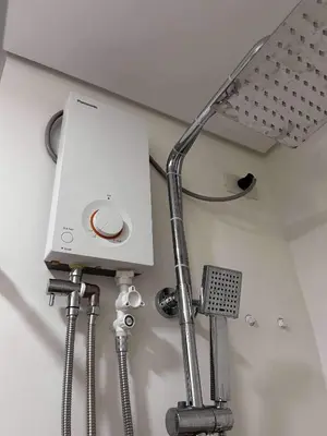a light on the wall of a bathroom at Newly build Condo Minimalist Charm in Manila
