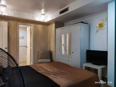 a bedroom with a bed and a tv in a room at Condo With Balcony And Bayview In Malate, Manila in Manila