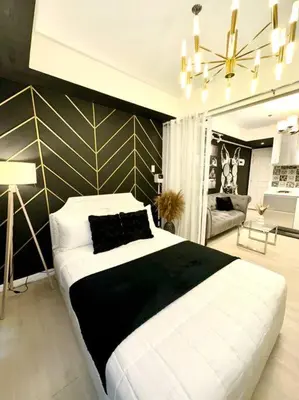 a bedroom with a large white bed in a room at Azure 1BR with Projector in Manila