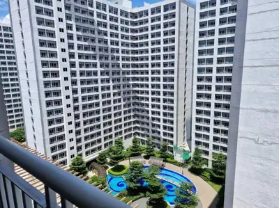 a view from a balcony of a large building at Cozy retreat w Balcony, Netflix, 100 mbps internet, Pool, near BGC in Manila