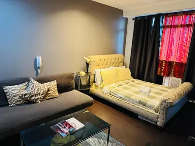 a living room with a couch and a coffee table at Gramercy Residences Studio with balcony Near Airport in Manila