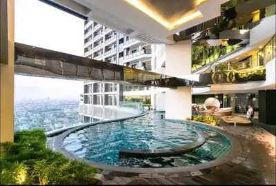 a swimming pool in the middle of a building at Gramercy Residences Studio with balcony Near Airport in Manila
