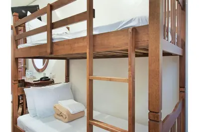 a bunk bed with a ladder towered over a room at Townhouse OAK Metro Manila Near Osmena Highway PNR Pasay formerly Avitel Hotel in Manila