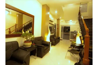 a living room with two couches and a staircase at Townhouse OAK Metro Manila Near Osmena Highway PNR Pasay formerly Avitel Hotel in Manila