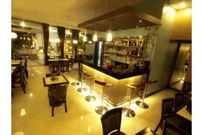 a restaurant with a bar and some tables and chairs at Townhouse OAK Metro Manila Near Osmena Highway PNR Pasay formerly Avitel Hotel in Manila