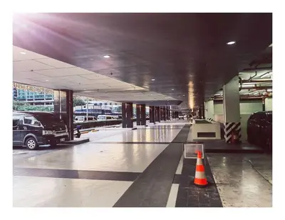 a parking lot with a truck parked in a parking garage at 2 Bedroom near MOA S Residences in Manila