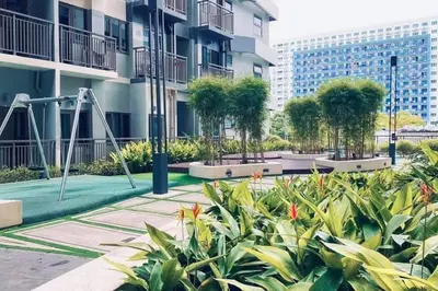 a park with a playground in a city at 2 Bedroom near MOA S Residences in Manila