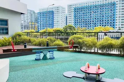a swimming pool with a table and a playground at 2 Bedroom near MOA S Residences in Manila