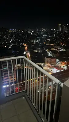 a view of a city at night from a balcony at Affordable & Spacious Condo in Makati in Manila