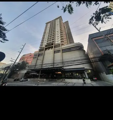 a tall building on the corner of a street at Affordable & Spacious Condo in Makati in Manila