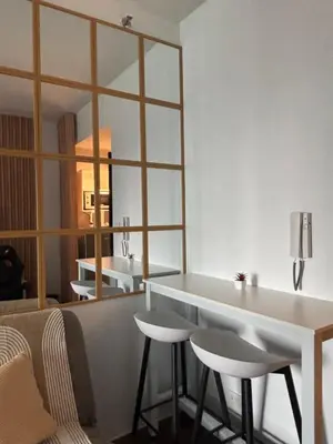 a living room with a counter and a mirror at Air Residences in Manila