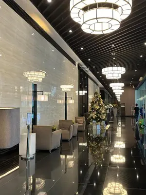 a lobby with chairs and a christmas tree in a building at Air Residences in Manila