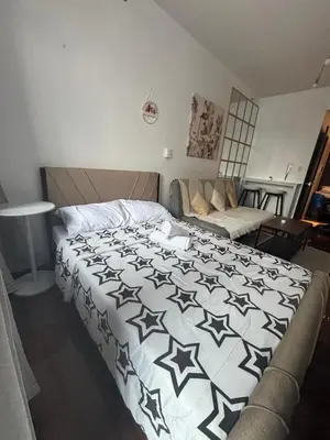 a bedroom with a bed with a black and white comforter at Air Residences in Manila