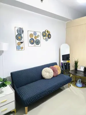 a blue couch sitting in a living room at Sea Residences by Richnell's Staycation 