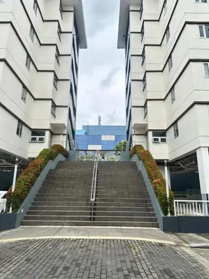 a set of stairs between two tall buildings at Enchantress Abode in Trece Martires
