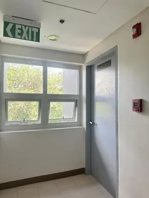 an empty room with a door and a window at Enchantress Abode in Trece Martires