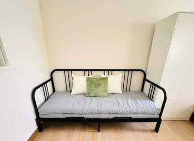 a bench with two pillows on it in a room at Enchantress Abode in Trece Martires