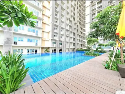 a swimming pool in the middle of a building at 10G Cozy Condo at Park McKinley West near Venice Mall in Manila