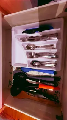 a white drawer filled with lots of utensils at Azure Urban Resort Residence in Manila