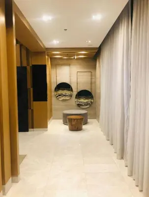 a hallway with a couch in a room with curtains at Kate's Place in Mall of Asia Complex in Manila