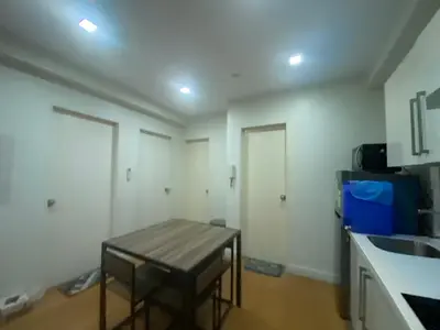 a kitchen with a counter and a stool in a room at The Home Ikigai in Manila