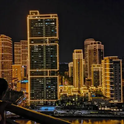 a city skyline at night with tall buildings at The Home Ikigai in Manila