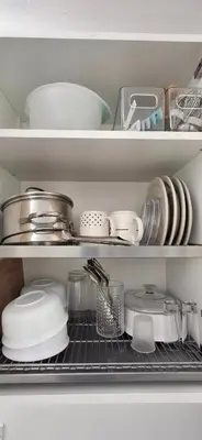 a refrigerator shelf filled with dishes and other kitchen items at Hideouts & Hangouts in Manila