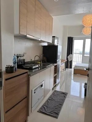 a kitchen with a sink and a stove top oven at Hideouts & Hangouts in Manila