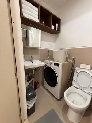 a bathroom with a washing machine and a toilet at Hideouts & Hangouts in Manila