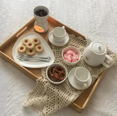 a tray with a tea kettle and plates of food at Hideouts & Hangouts in Manila