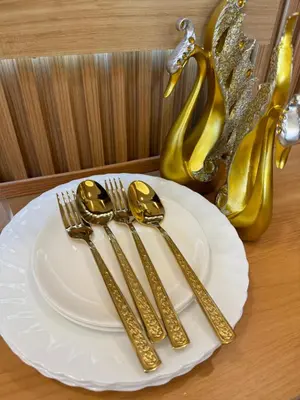 a plate with gold fork and knife on a table at Grand Suites Shore 3 Residences in Manila