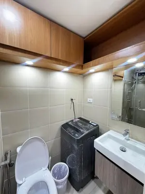 a bathroom with a toilet and a sink at Grand Suites Shore 3 Residences in Manila