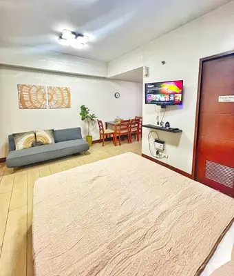 a living room with a couch and a table at Nara Homes at Palm Tree Villas in front of NAIA Terminal 3 in Manila