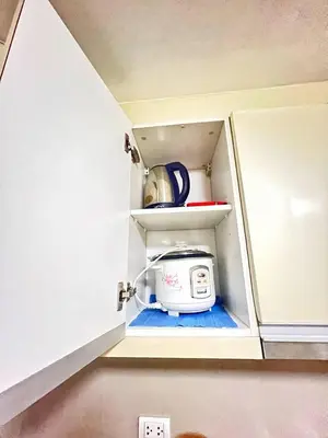 a toaster is sitting inside of a kitchen cabinet at Nara Homes at Palm Tree Villas in front of NAIA Terminal 3 in Manila