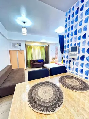 a living room with a couch and a table at Nara Homes at Palm Tree Villas in front of NAIA Terminal 3 in Manila
